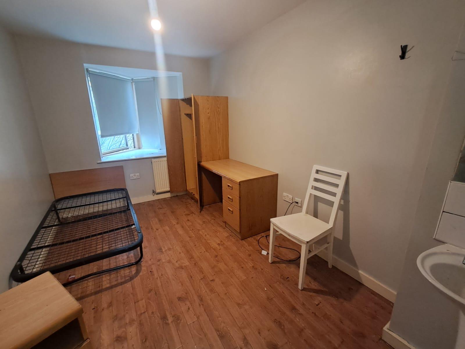 Bathroom and bedroom area clean and clear after a deep clean at a supported housing site