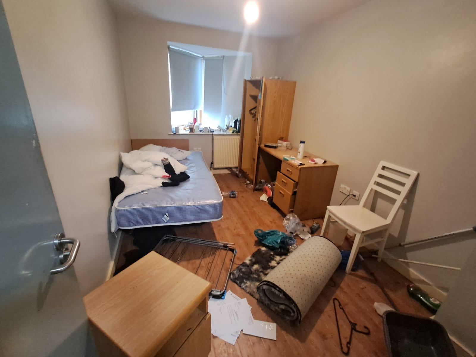 Room full of rubbish and belongings before a deep clean and clearance